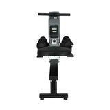 Black and silver rowing machine with digital display, foot straps, and padded seat on white background