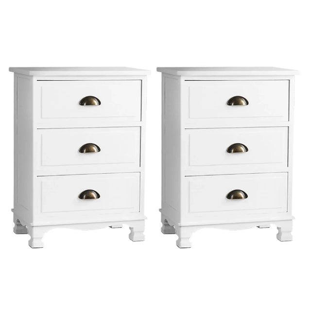 Pair of white three-drawer nightstands with brass cup handles on white background