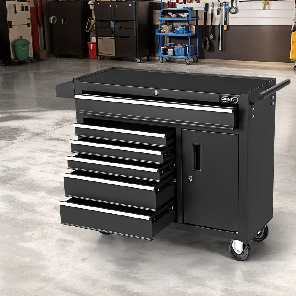 Black GIANTZ rolling tool chest with multiple open drawers and a side cabinet in a garage workshop