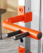 Orange fitness equipment J-hook attachment on gym power rack with metal pegs