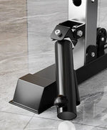 Black metal weight holder on gym rack base with bolts on a gray marble floor