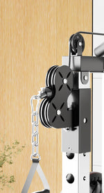Close-up of black pulley system with chain on gym equipment against wood wall