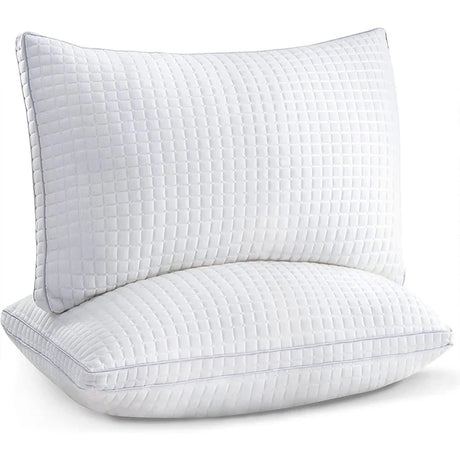Two white quilted pillows stacked showcasing soft textured bedding accessories