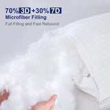 Hand holding fluffy white 3D and 7D microfiber filling from a white pillow with textured cover