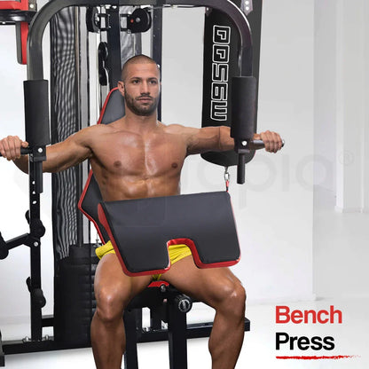 Man using a home gym machine for bench press workout, wearing yellow shorts in a fitness room.