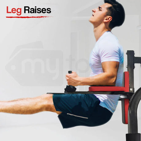 Man performing leg raises on gym equipment, core workout, athletic training, fitness exercise