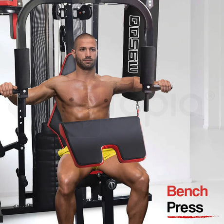 Shirtless man using home gym bench press machine for chest workout in fitness room