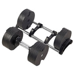 Adjustable black dumbbell with metal handle on a holder, home gym fitness equipment