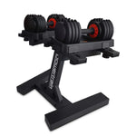 Powertrain adjustable dumbbells with black weight plates and red dial on black stand