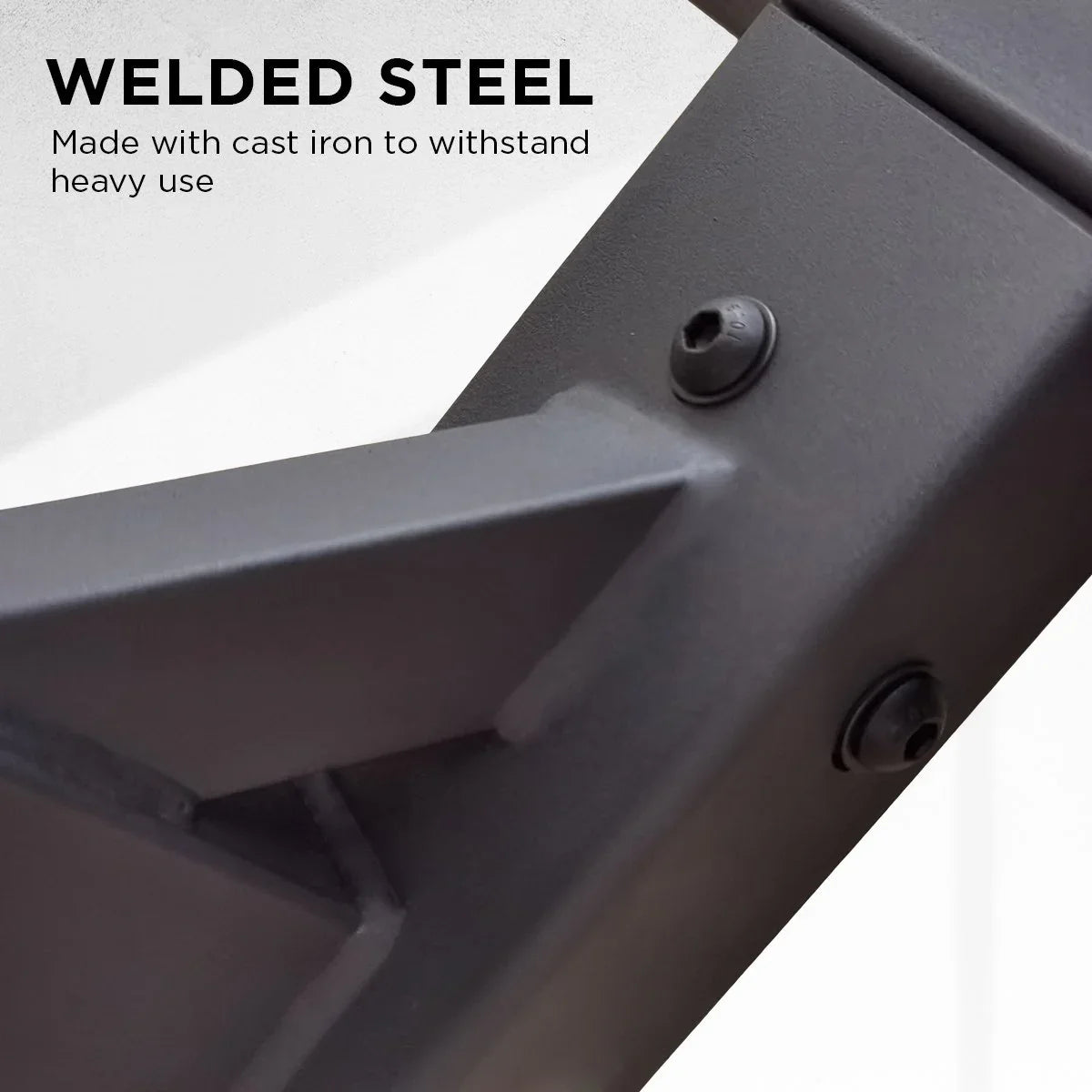 Close-up of black welded steel frame with cast iron screws, highlighting durable heavy-use construction