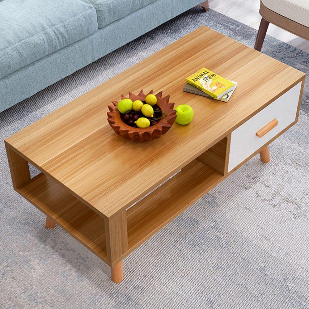 Modern wooden coffee table with drawer, fruit bowl, book, in living room setting