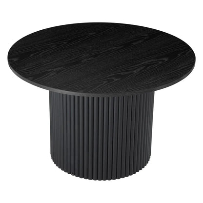 Black round dining table with a ribbed cylindrical base and wood grain texture