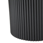 Close-up of black fluted metal table base with vertical ridged texture