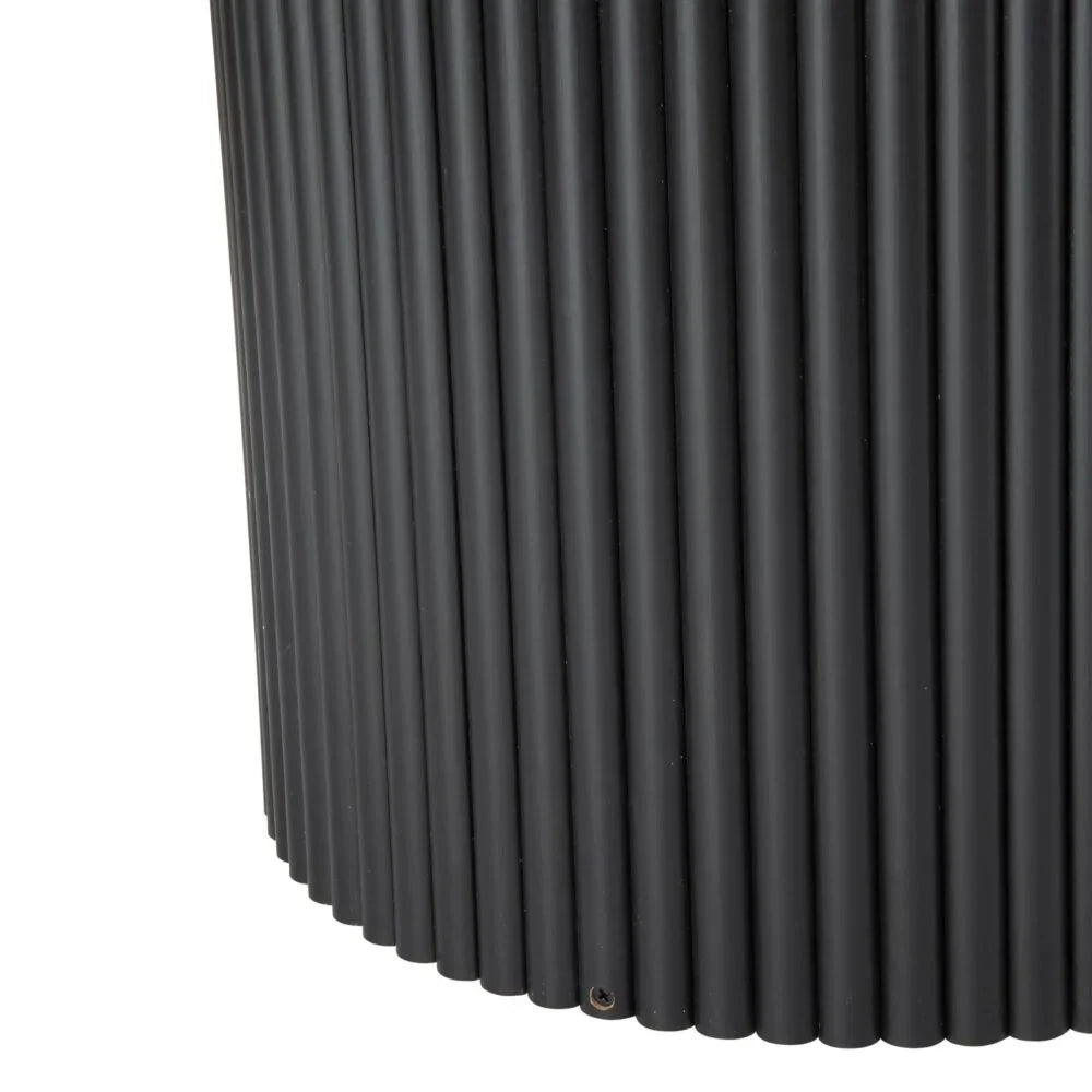 Close-up of black fluted metal table base with vertical ridged texture
