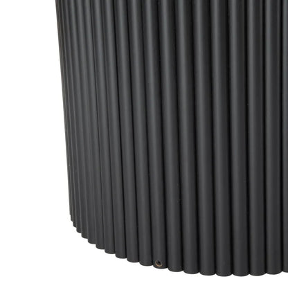 Close-up of black fluted metal table base with vertical ridged texture
