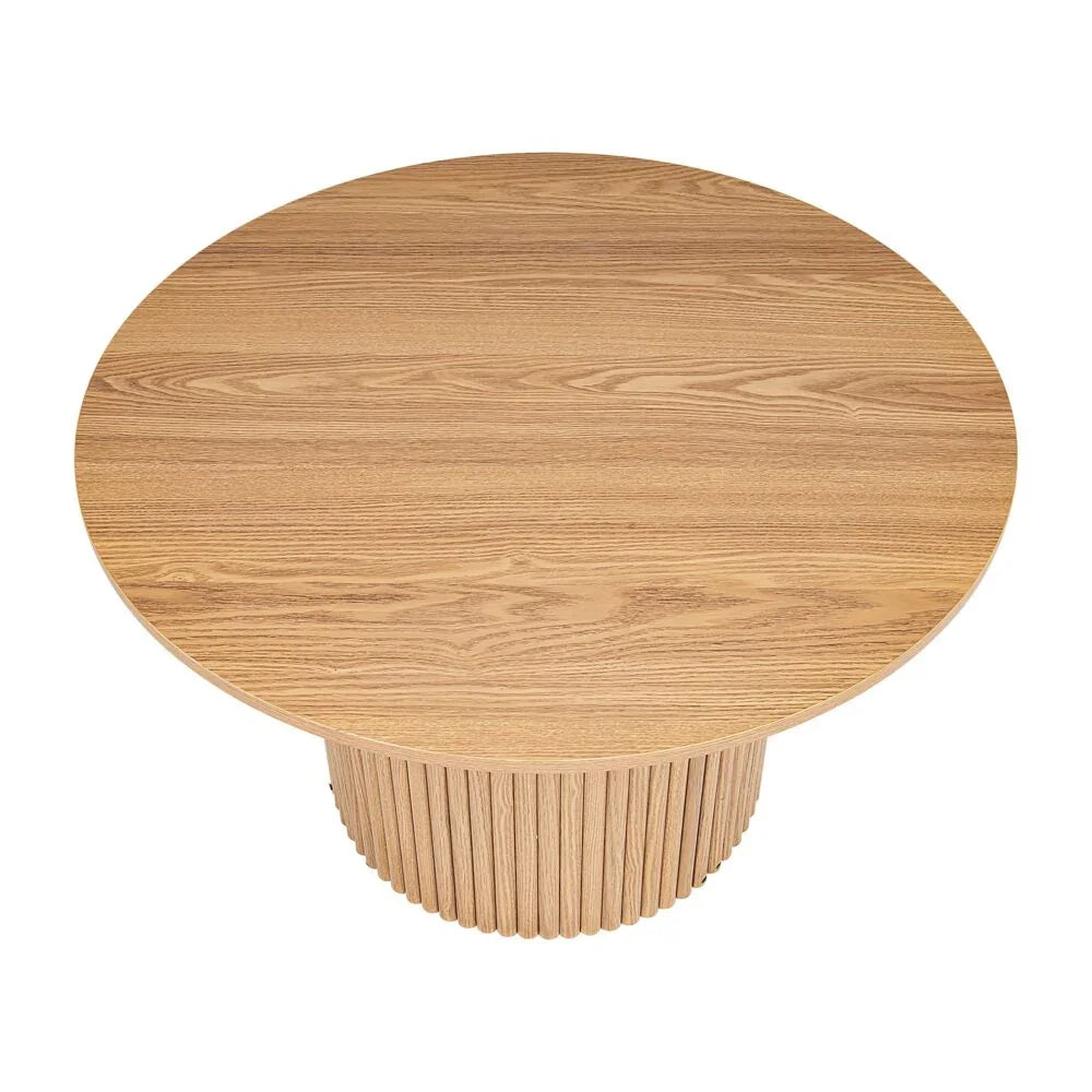 Round natural wood dining table with fluted pedestal base, modern minimalist design