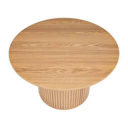 Round natural wood dining table with fluted pedestal base, modern minimalist design