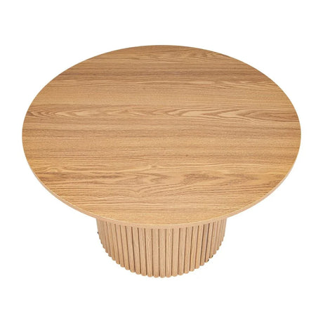 Round natural wood dining table with fluted pedestal base, modern minimalist design