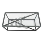 Rectangular glass coffee table with black geometric metal frame and modern twisted base design