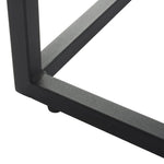 Close-up of black metal table leg frame with a matte finish against a white background