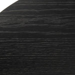 Black wood grain textured table surface close-up