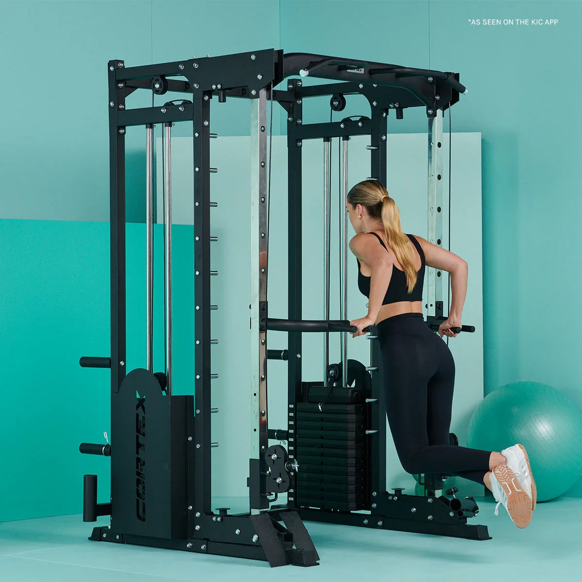 Woman using Cortex V420 Smith machine for triceps dips in modern home gym.