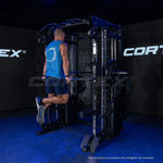 Man using CORTEX power rack machine dip station in gym with dark background