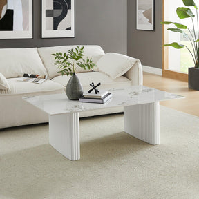 Modern living room with white marble coffee table, cream sofa, and minimalist decor