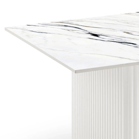 Modern white marble dining table with fluted base and black veining detail