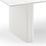 Modern white fluted table base with marble tabletop, minimalist furniture design