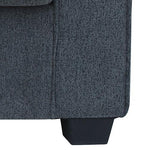 Dark gray fabric sofa corner with black tapered plastic leg, modern furniture detail