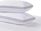 Two white pillows with gray breathable mesh sides stacked on a white surface for bedding