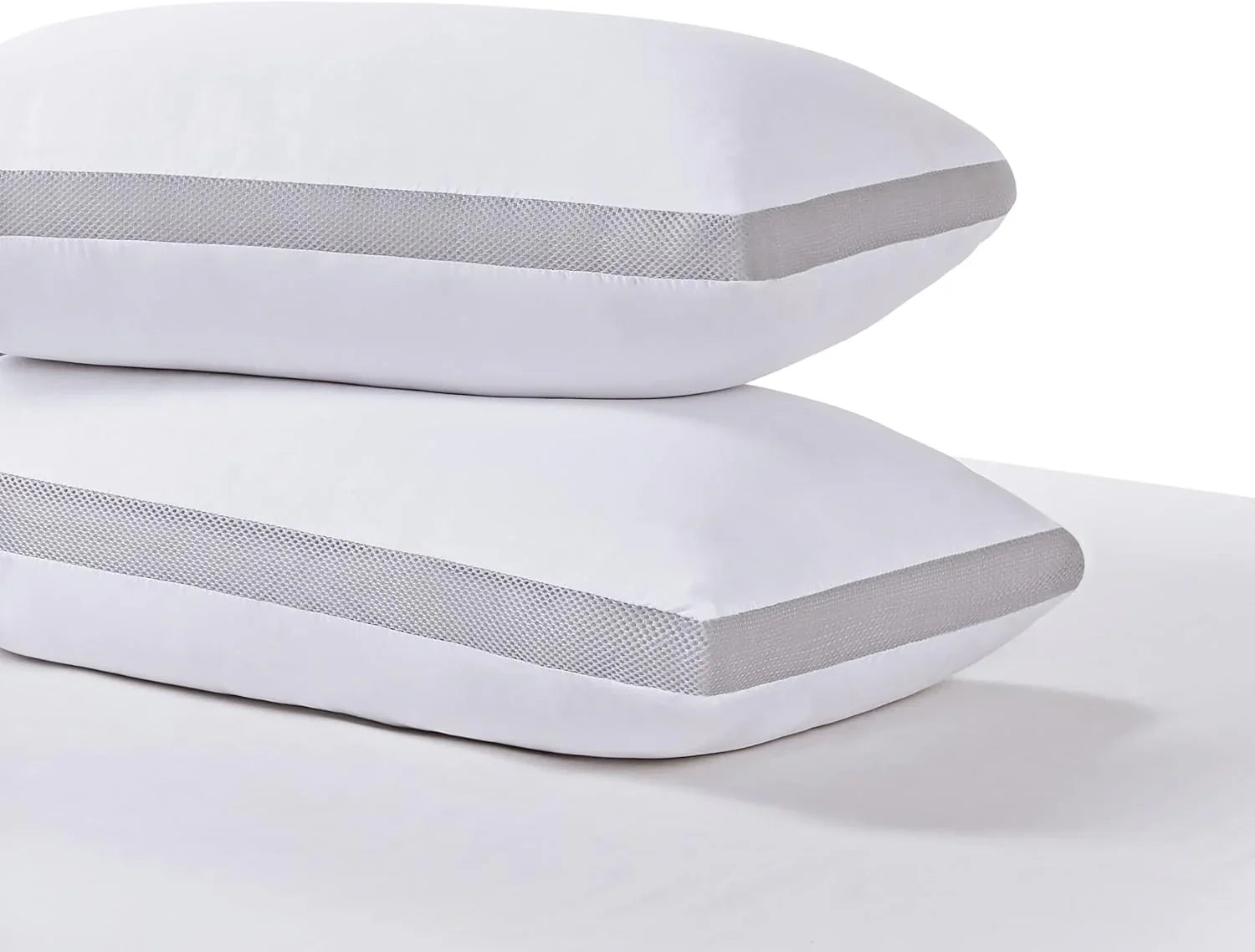 Two white pillows with gray breathable mesh sides stacked on a white surface for bedding