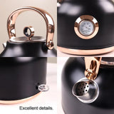 Black kettle with rose gold handle, built-in temperature gauge, spout, and spout cover details