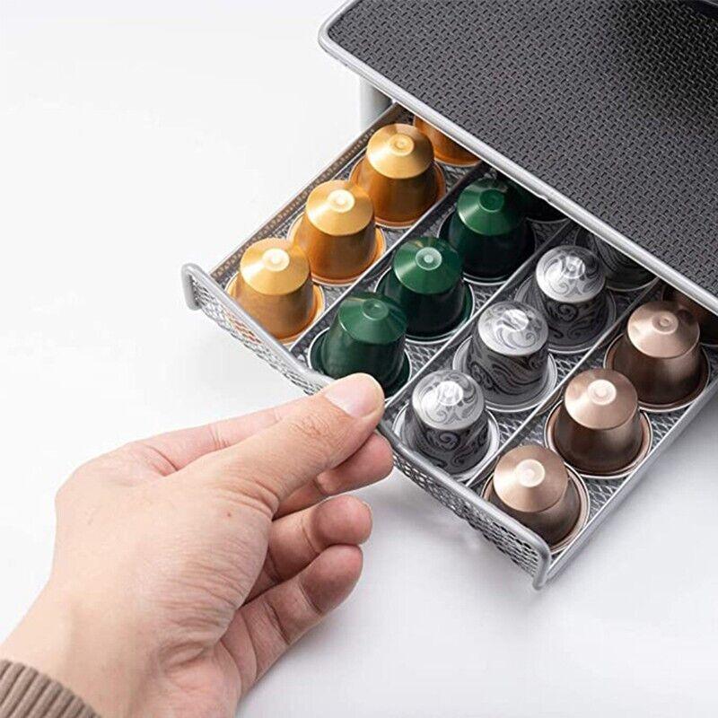Hand pulling out a gray metal drawer organizer filled with variously colored coffee capsules
