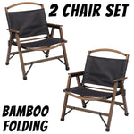 Set of two black fabric bamboo folding chairs with wooden armrests