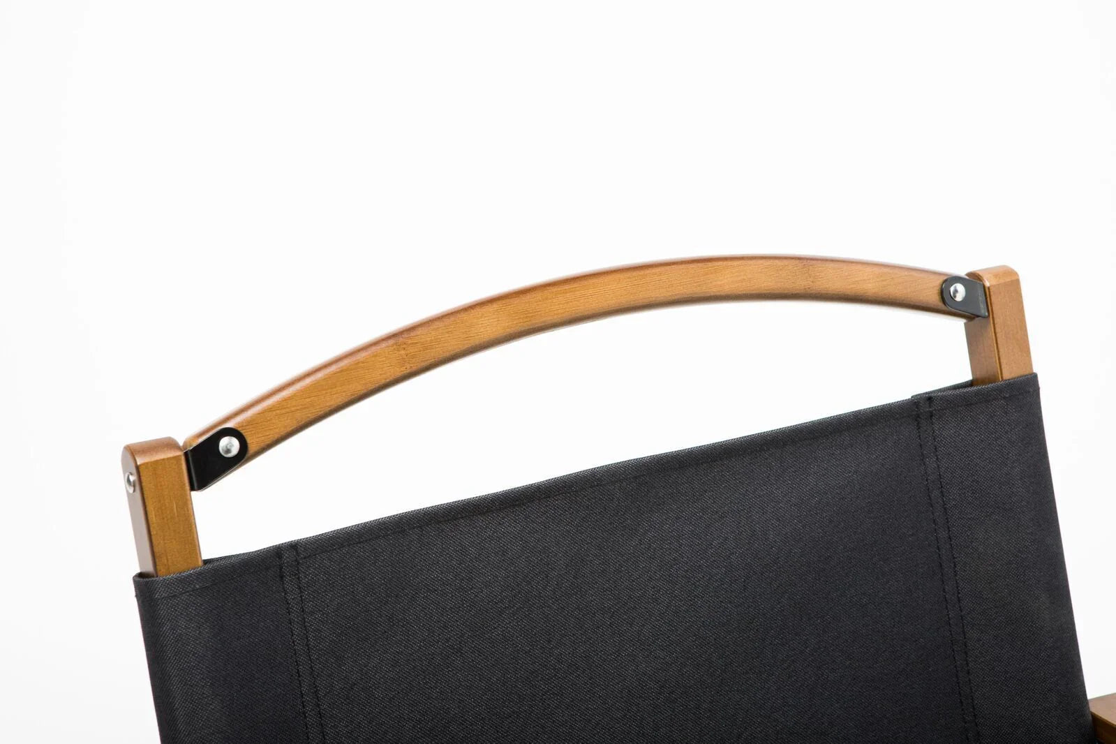 Close-up of black fabric and curved wooden backrest of a modern chair