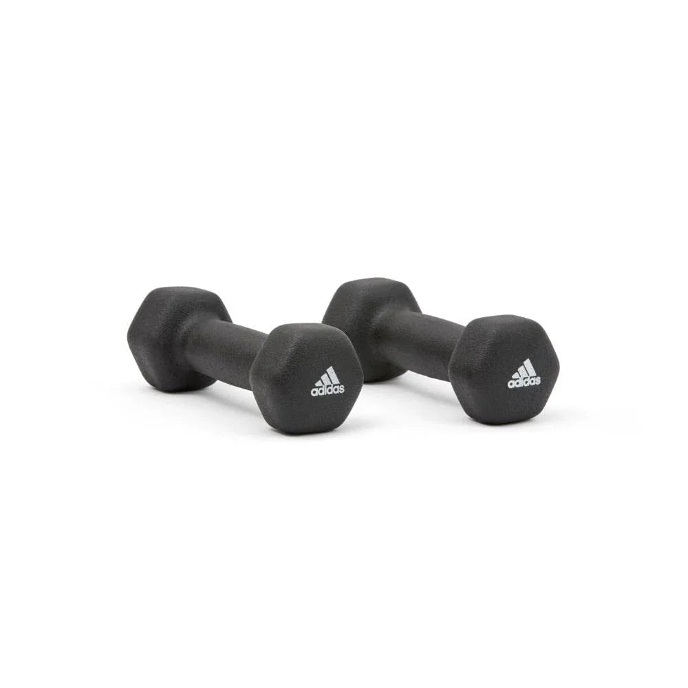 Pair of black Adidas hexagonal dumbbells on white background for strength training
