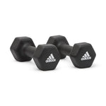 Pair of black Adidas hex dumbbells with white logos on a white background