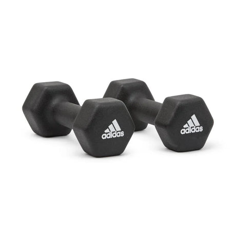 Pair of black Adidas hex dumbbells with white logos on a white background