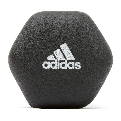 Black Adidas hexagonal dumbbell with white Adidas logo on textured surface
