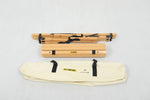 Folded wooden camping table with black metal hinges and cream carrying bag labeled ECAMPING