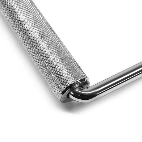 Close-up of textured metal handle attached to a polished chrome L-shaped bar against white background