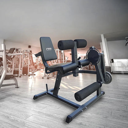 Black adjustable leg curl and extension machine in modern gym setting