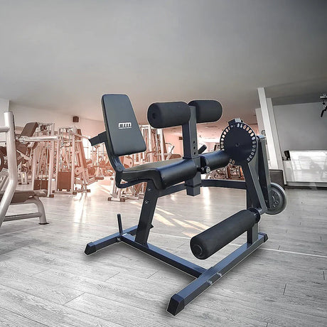 Black adjustable leg curl and extension machine in modern gym setting