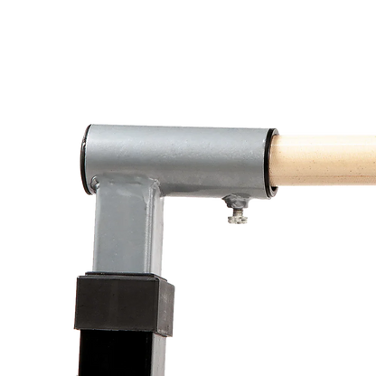 Close-up of metal frame joint with attached wooden dowel on black background