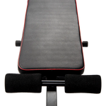 Adjustable weight bench seat with black padding and red trim for home gym workouts