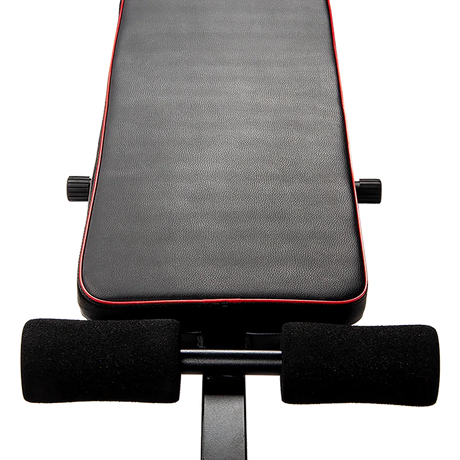 Adjustable weight bench seat with black padding and red trim for home gym workouts
