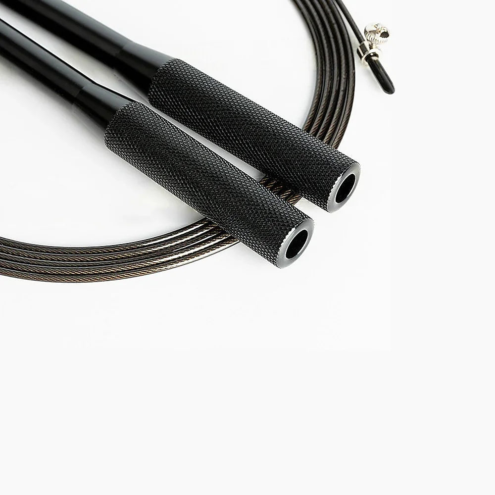 Black jump rope with textured metal handles and steel cable on white background