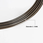 Coiled steel wire rope with 2.5 mm diameter on white background